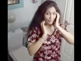 A stunning young woman flaunts her breasts in a seductive video