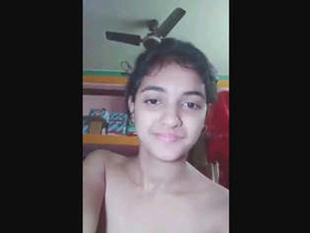 Young girl pleasures herself with her fingers