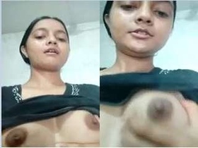 A cute webcam girl flaunts her breasts for the camera