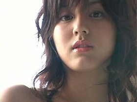 Yumi SugiMoto, the Japanese beauty, flaunts her assets in a sexy pose