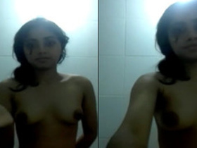 Desi babe in the nude records a video of herself playing with her nipples