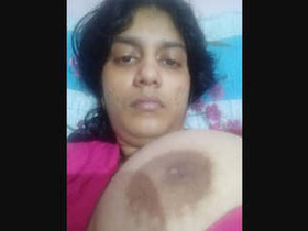 A stunning Desi girl flaunts her ample bosom in a seductive display