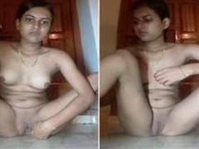 A young Indian woman removes her violet pants and spreads her legs on the floor