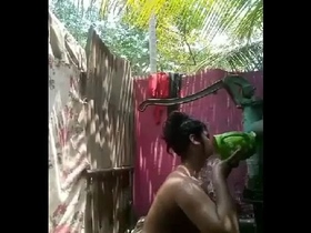 Women take a shower outdoors in a village