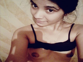Watch a college girl show off her natural boobs in a cute video