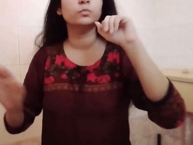 Indian bhabhi with long hair strips and takes a nude selfie in the bathroom